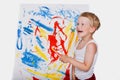 Little kid painting with paintbrush picture on easel. Education. Creativity Royalty Free Stock Photo