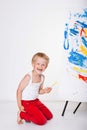 Little kid painting paints picture on easel. Education. Creativity Royalty Free Stock Photo