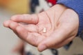 Little kid palm holding first lost milk tooth. Little hand with loose tooth. Kids dentistry. A child holding his first lost milk