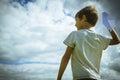 Little kid with paper planes against blue sky Royalty Free Stock Photo