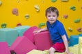 Little kid play with soft blocks at indoor children playground