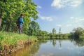 Child play fishing near lake. Royalty Free Stock Photo