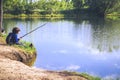 Child play fishing near lake. Royalty Free Stock Photo