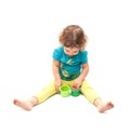 Little kid playing alone with nesting blocks