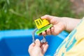 little kid is playing in sandbox with his truck toy Royalty Free Stock Photo