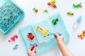 Little kid playing with water beads, crafting cute animals, creative hobby for kids, top view