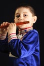 Little kid playing wooden flute Royalty Free Stock Photo