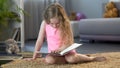 Little kid reading, laughing at funny story in childrens book, early education Royalty Free Stock Photo
