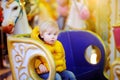 Little kid riding on colorful carousel merry go round. City outdoors entertainment for children Royalty Free Stock Photo