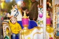 Little kid riding on colorful carousel merry go round Royalty Free Stock Photo