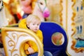 Little kid riding on colorful carousel merry go round during market Royalty Free Stock Photo