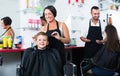 Little kid sitting in chair and getting hair cut Royalty Free Stock Photo