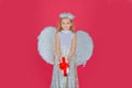 Little kids angel with present gift. Little angel with white wings holds gift. Cute angel child girl with angels wings Royalty Free Stock Photo