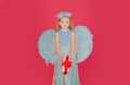 Little kids angel with present gift. Little angel with white wings holds gift. Cute angel child girl with angels wings Royalty Free Stock Photo