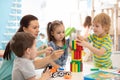 Little kids build block toys at home or daycare. Kids playing with color blocks. Educational toys for preschool and kindergarten Royalty Free Stock Photo