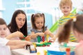 Little kids build block toys at playschool or daycare. Kids playing with color blocks. Educational toys for preschool Royalty Free Stock Photo