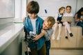 little kids with diy robot embracing