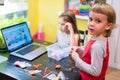 Little kids, girl and boy, engaged in creative modeling from clay or plasticine in a room at a table, watching an online class les Royalty Free Stock Photo