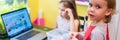 Little kids, girl and boy, engaged in creative modeling from clay or plasticine in a room at a table, watching an online class les Royalty Free Stock Photo