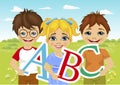 Little kids holding the abc letters in flower field Royalty Free Stock Photo