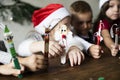 Little kids holding Christmas character decorated popsicle sticks Royalty Free Stock Photo