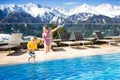 Kids in outdoor swimming pool of Alpine resort Royalty Free Stock Photo