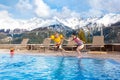 Kids in outdoor swimming pool of Alpine resort Royalty Free Stock Photo
