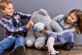 Little kids play with teddy bear. Royalty Free Stock Photo