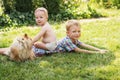 Little kids playing with dog Pomeranian spitz