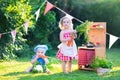 Little kids playing with toy kitchen in the garden Royalty Free Stock Photo