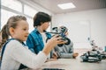 little kids sitting at class with diy robot stem