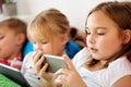 Little kids with smartphone in bed at home Royalty Free Stock Photo