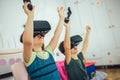 Kids in virtual reality headsets playing video game at home Royalty Free Stock Photo
