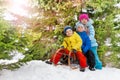 Little kids and winter fun on sledge in park Royalty Free Stock Photo