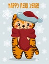 A cute tiger cub dressed like Santa, a little red kitty wearing a hat and a scarf