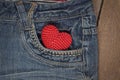 Little knit heart in the front pocket of blue jeans