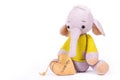 Little knitted baby elephant and wooden heart. Soft knitted elephant and heart.