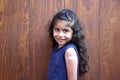 Little latin girl with curly hair happy shows her arm recently vaccinated against Covid-19 in the new normal for the Coronavirus p