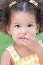 Little latin girl picking her nose Royalty Free Stock Photo