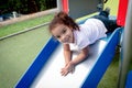 Little Latina girl playing in the park outdoors