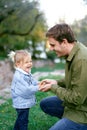 Little laughing girl holding her hands in her father palms Royalty Free Stock Photo