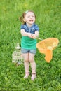 Little laughing girl holds orange butterfly net on Royalty Free Stock Photo