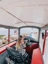 Little laughing girl sitting behind the wheel of a tractor Royalty Free Stock Photo