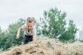 Little laughing girl 3-4 years old jumps and plays in hay stack, on background of trees Royalty Free Stock Photo