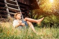 Little lazy boy sleeps under old hayloft in garden