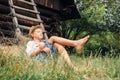 Little lazy boy sleeps under old hayloft in garden