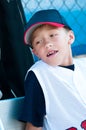 Little league baseball player in dugout Royalty Free Stock Photo