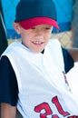 LIttle league baseball player in dugout Royalty Free Stock Photo