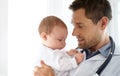 Little life in his hands. a handsome male doctor holding a baby. Royalty Free Stock Photo