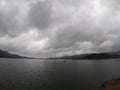 A little of light above the calm water in the Wadas Lintang reservoir of Wonosobo Royalty Free Stock Photo